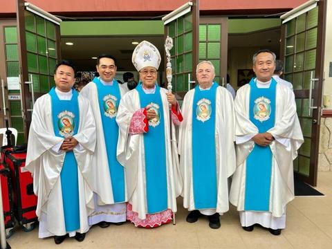 A bishop and priests wearing Flame of Love vestments at the Church of the Immaculate Heart of Mary
