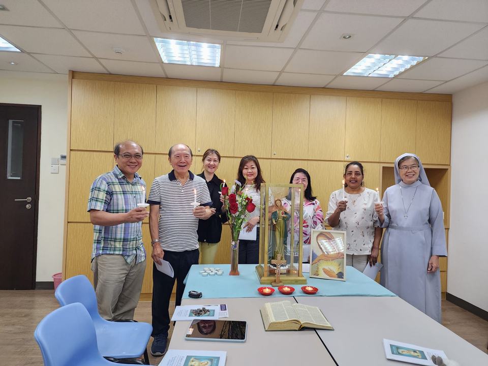Members preparing statues and materials for home visitations in the parish meeting room