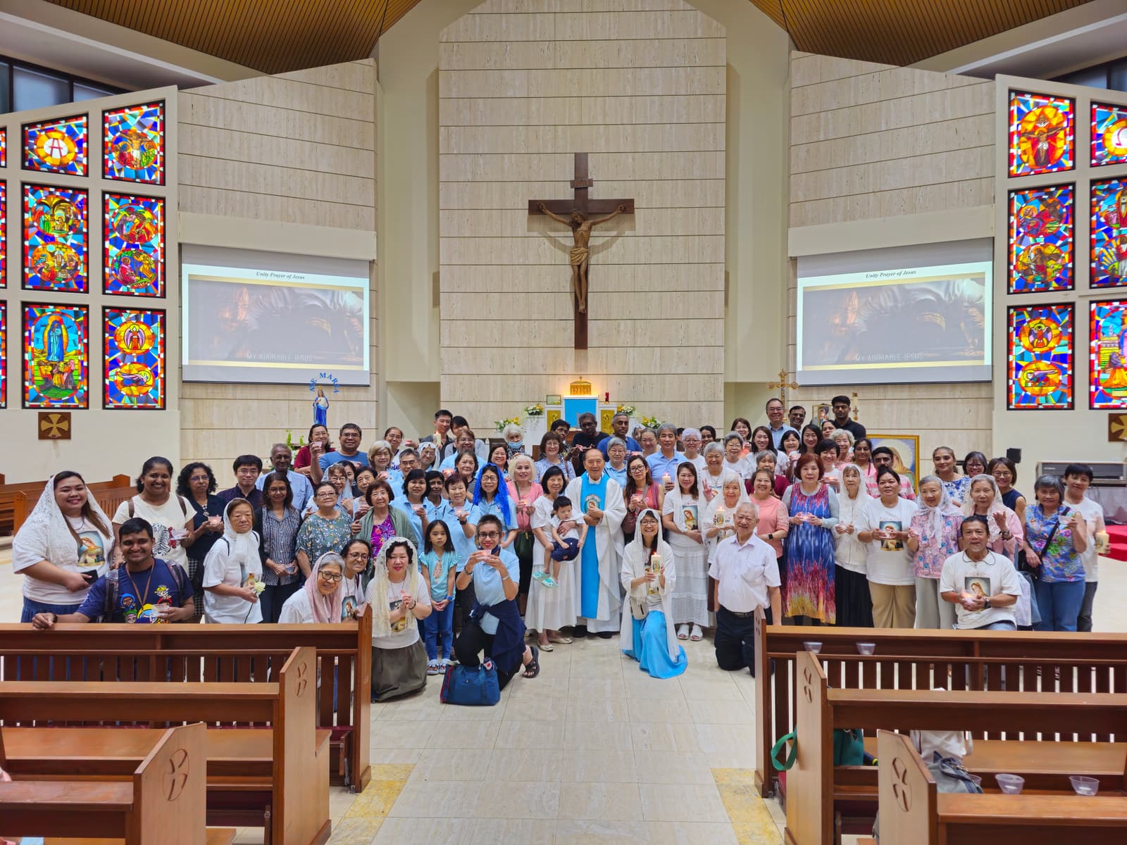 The Flame of Love Singapore community filling the nave of the Church of the Immaculate Heart of Mary beneath the crucifix